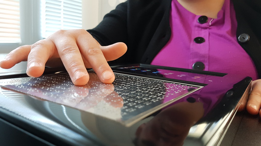 One man using digital braille screen